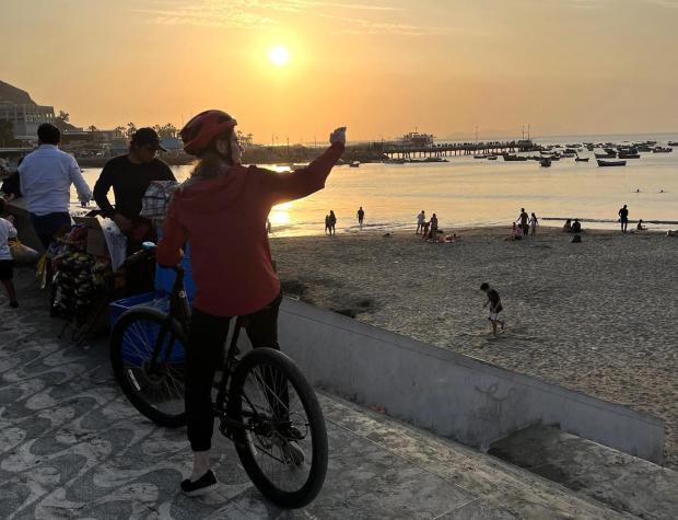 A bike tour stops for a view along the oceanfront in the Barranco district.