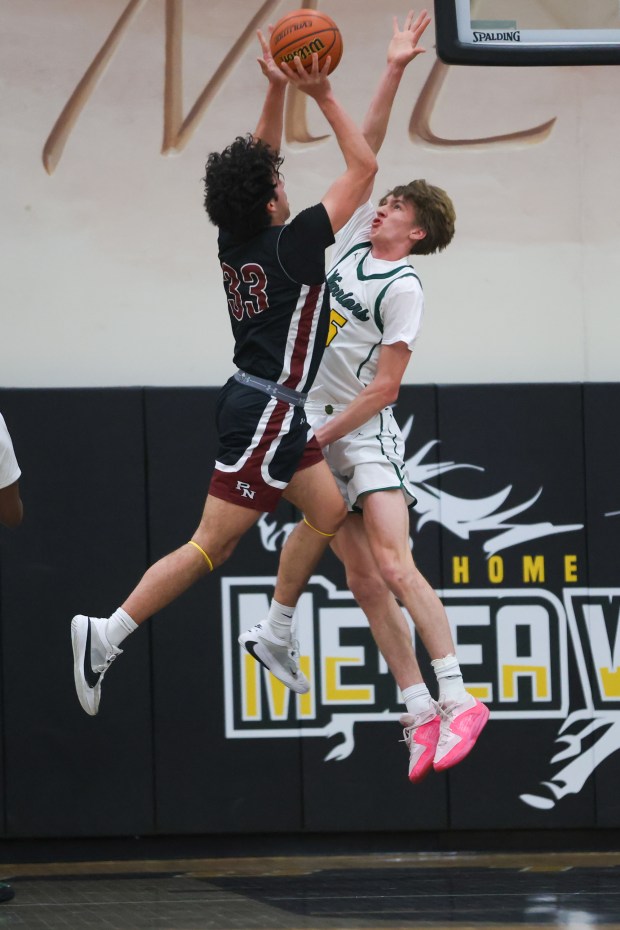 Waubonsie Valley's Cade Valek (25) contests a shot during the Class 4A Metea Valley Regional final against Plainfield North on Thursday, Feb. 22 2024. (Troy Stolt for the Aurora News Beacon)