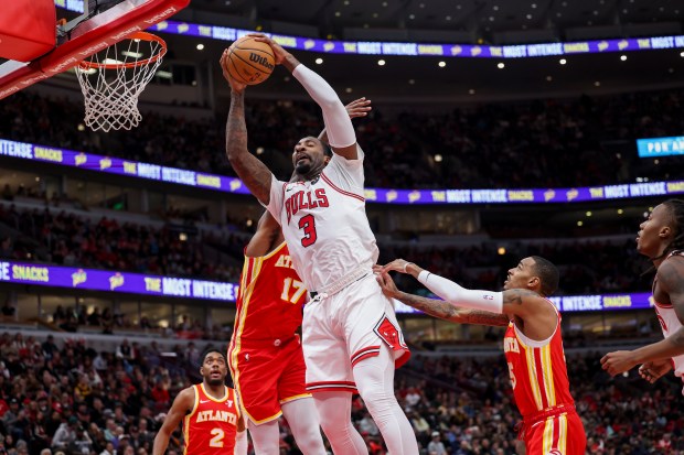 Bulls center Andre Drummond grabs a rebound in front of Hawks forward Onyeka Okongwu (17) during the second quarter on Dec. 26, 2023, at the United Center.