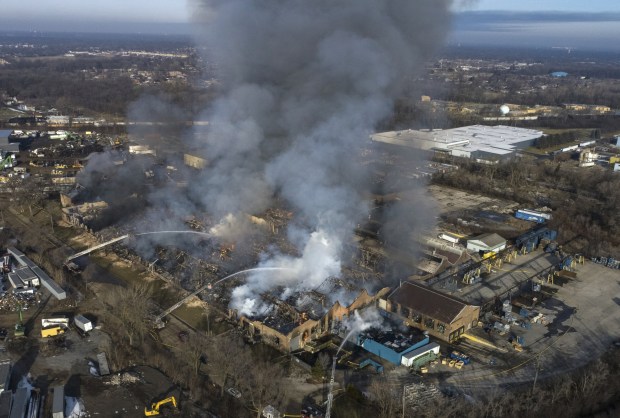 Firefighters work to put out a blaze Feb. 6, 2023, at a Morgan Li warehouse in Chicago Heights. The company recently broke ground for a new factory and warehouse at the site. (Vincent Johnson / Chicago Tribune)