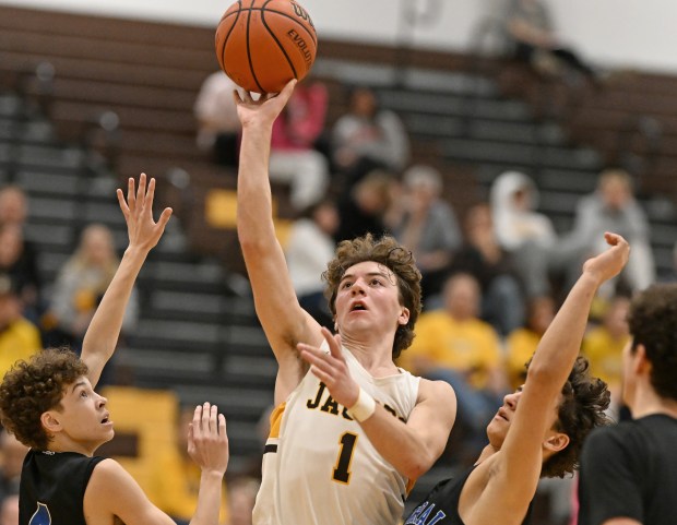 Jacobs' Ben Jurzak (1) puts up a shot in between Burlington Central's Ryan Carpenter (4) and Lucas Kerr (3) during the 4th quarter of Friday's game, February 9, 2024. Burlington Central won the game, 59-44. (Brian O'Mahoney for the The Courier-News)