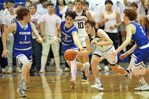 Kaneland's Preston Popovich (4) drives through Marmion defenders Matthew Stewart (1), Braden Harms (0) and Caden Anderson (2) during the Class 3A Marmion Regional final game on Friday, Feb. 23, 2023 in Aurora. Kaneland won, 58-50.H. Rick Bamman / For the Beacon-News