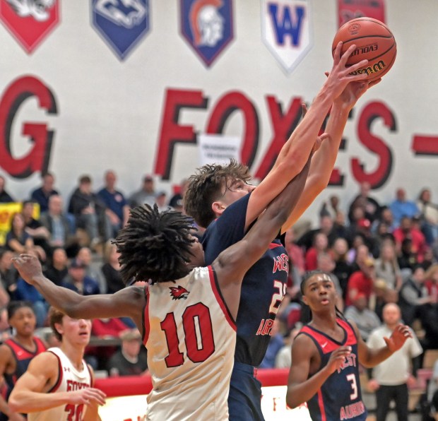 West Aurora's Gabriel Gonzales grabs a rebound in front of Yorkville's Kaevian Johnson. West Aurora defeated Yorkville 64-53 in a Class 4A Yorkville Regional semifinal boys basketball game Wednesday, February 21, 2024, in Yorkville, Illinois. (Jon Langham/photo for the Beacon-News)