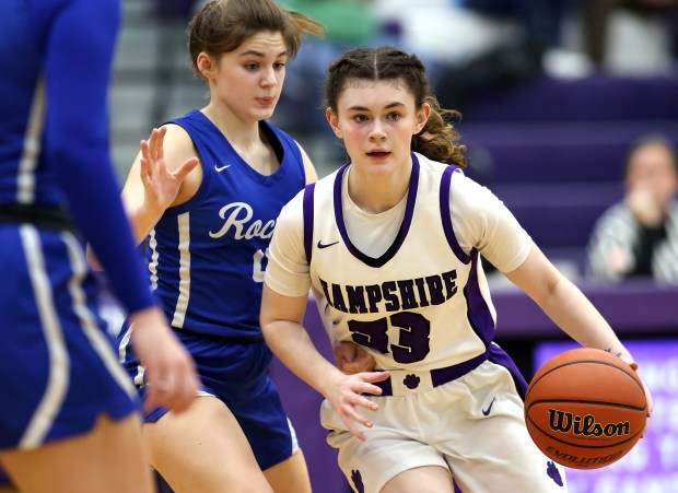 Hampshire's Ashley Herzing (33) drives to the lane past Burlington Central's Emersyn Fry (4) during a Fox Valley Conference game on Wednesday, Feb. 7, 2024 in Hampshire. Hampshire won, 58-50.H. Rick Bamman / For the Beacon-News