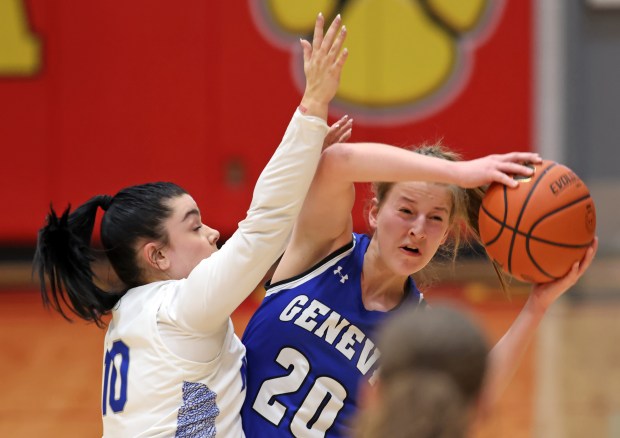 Geneva's Caroline Madden (20) is defended by St. Charles North's Mia Hoppes (10) during a Class 4A Batavia Sectional semifinal game on Tuesday, Feb. 20, 2023 in Batavia.H. Rick Bamman / For the Beacon-News