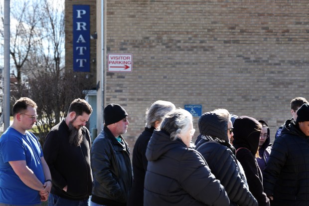 Tom Wehner, second from left, the father of Trevor Wehner, joins other mourners gathered outside the former Henry Pratt Company building in Aurora on Thursday, Feb. 15, 2024, the fifth anniversary of a massing shooting there in which Trevor was killed. (Terrence Antonio James/Chicago Tribune)