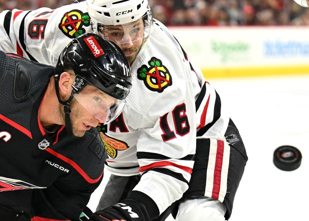 RALEIGH, NORTH CAROLINA - FEBRUARY 19: Jordan Staal #11 of the Carolina Hurricanes and Jason Dickinson #16 of the Chicago Blackhawks eye the puck during the first period at PNC Arena on February 19, 2024 in Raleigh, North Carolina. (Photo by Grant Halverson/Getty Images) ** OUTS - ELSENT, FPG, CM - OUTS * NM, PH, VA if sourced by CT, LA or MoD **