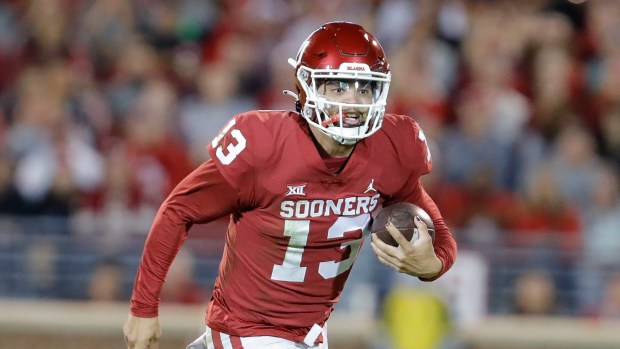 Oklahoma quarterback Caleb Williams (13) runs for a touchdown against TCU during an NCAA football game on Saturday, Oct. 16, 2021, in Norman, Oklahoma. (AP Photo/Alonzo Adams)