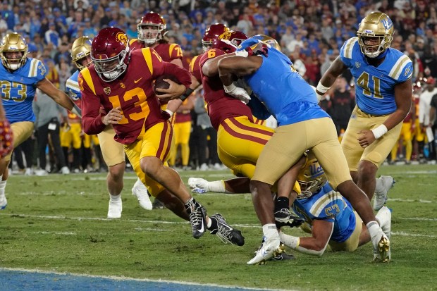 Southern California quarterback Caleb Williams (13) runs in for a touchdown during the first half of an NCAA college football game against UCLA Saturday, Nov. 19, 2022, in Pasadena, Calif. (AP Photo/Mark J. Terrill)