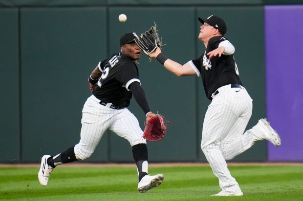 Chicago White Sox right fielder Oscar Colas, left, and right fielder Gavin Sheets, right, go for the ball but Sheets makes the catch during the fourth inning of a baseball game against the Detroit Tigers, Saturday, Sept. 2, 2023, in Chicago. (AP Photo/Erin Hooley)