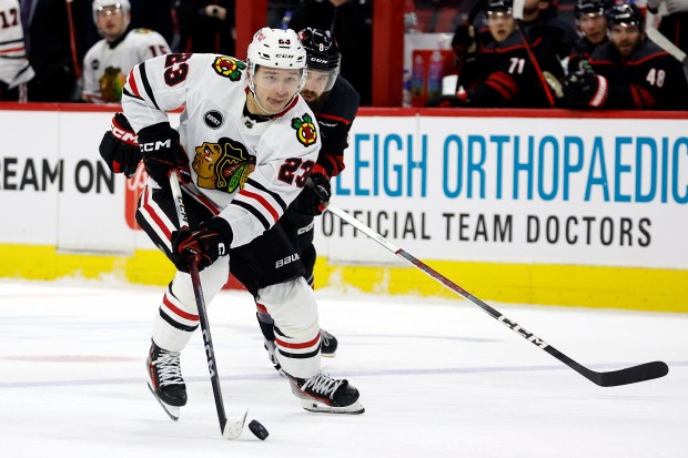 Chicago Blackhawks' Philipp Kurashev (23) skates with he puck against the Carolina Hurricanes during the third period of an NHL hockey game in Raleigh, N.C., Monday, Feb. 19, 2024. (AP Photo/Karl B DeBlaker)