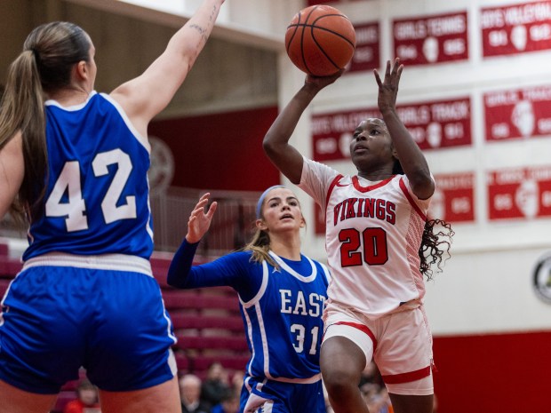 Homewood-Flossmoor's Jaeda Murphy (20) puts up a floater as Lincoln-Way East's Hayven Smith (42) attempts to block the shot during a Southwest Suburban Blue game in Flossmoor on Tuesday, Jan. 23, 2024.