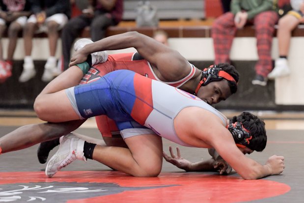 East Aurora's Arnold Walker wrestles West Aurora's Alfonso Aguilar at 215 pounds during the semi finals of the Class 3A East Aurora Regional in Aurora on Saturday, Feb. 3, 2024. (Mark Black / The Beacon-News)User Upload Caption: TK