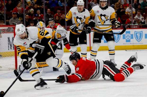 Chicago Blackhawks center Ryan Donato (8) fights for the puck during a game between the Chicago Blackhawks and the Pittsburgh Penguins on Thursday, Feb. 15, 2024, at the United Center in Chicago. (Vincent Alban/Chicago Tribune)