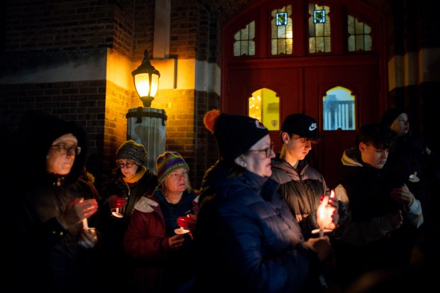 Mourners gather for a vigil for Daveon Gibson, Feb. 1, 2024, near Nicholas Senn High School in Chicago. Gibson, a student at the school, was shot along with two other students after leaving the school the day prior. Gibson died as a result of his injuries. (Vincent Alban/Chicago Tribune)