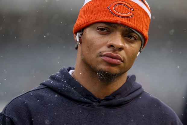 Bears quarterback Justin Fields warms up in the snow to face the Falcons on Dec. 31, 2023, at Soldier Field. (Brian Cassella/Chicago Tribune)