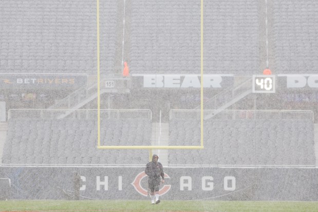 Chicago Bears guard Lucas Patrick walks out into the snow at Soldier Field before the start of a game on Sunday, Dec. 31, 2023. (Stacey Wescott/Chicago Tribune)