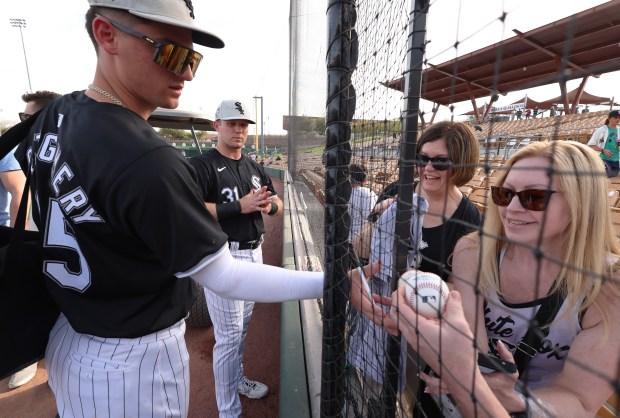 Chicago White Sox players Colson Montgomery, right, and Zach DeLoach, center, sign autographs after their game against the Seattle Mariners at Camelback Ranch on Sat., Feb. 24, 2024, in Glendale, Arizona. The White Sox won 8-7. (Stacey Wescott/Chicago Tribune)