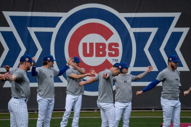 Chicago Cubs players warm up during spring training at Sloan Field in Mesa, Ariz., on Saturday, Feb. 25, 2023. (E. Jason Wambsgans/Chicago Tribune)