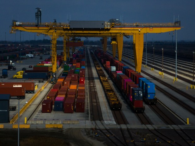 Shipping containers are lifted at the Union Pacific Global IV intermodal yard near Joliet, Nov. 6, 2023. (E. Jason Wambsgans/Chicago Tribune)