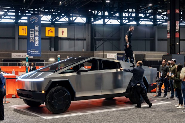 Visitors check out a Tesla Cybertruck on display during the Chicago Auto Show preview day, Feb. 8, 2024, at McCormick Place. The show is scheduled for Feb. 10 to 19. (Brian Cassella/Chicago Tribune)