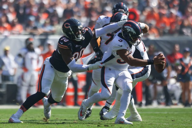 Broncos quarterback Russell Wilson tries to escape Bears defensive end Dominique Robinson on Oct. 1, 2023, at Soldier Field. (Eileen T. Meslar/Chicago Tribune)