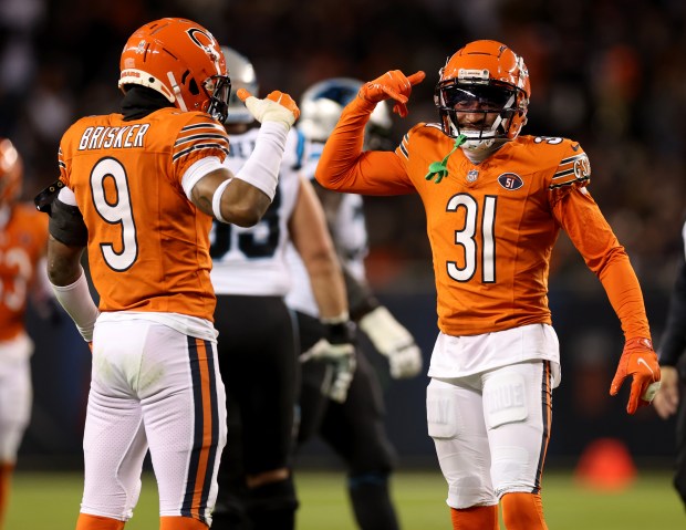 Bears safety Jaquan Brisker (9) and cornerback Jaylon Jones (31) celebrate after a big stop against the Panthers on Nov. 9, 2023, at Soldier Field. (Chris Sweda/Chicago Tribune)