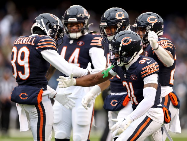 Bears cornerback Josh Blackwell, left, celebrates with teammates after making a nice tackle on a punt return by the Lions on Dec 10, 2023, at Soldier Field. (Chris Sweda/Chicago Tribune)