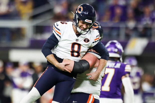 Bears center Lucas Patrick lifts Cairo Santos after the kicker made a 30-yard field goal to put the Bears ahead with 10 seconds left against the Vikings on Nov. 27, 2023, at U.S. Bank Stadium in Minneapolis. (Eileen T. Meslar/Chicago Tribune)