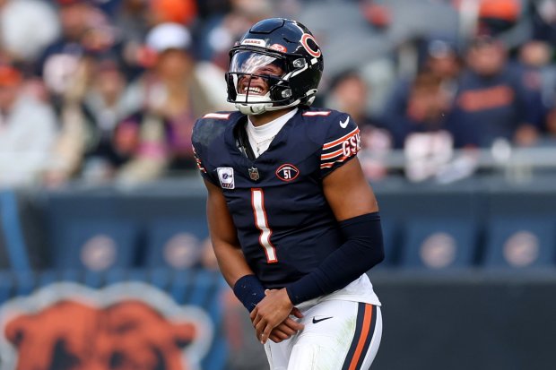 Chicago Bears quarterback Justin Fields (1) holds his wrist as he comes off the field in the third quarter of a game against the Minnesota Vikings at Soldier Field in Chicago on Oct. 15, 2023. (Chris Sweda/Chicago Tribune)User Upload Caption: