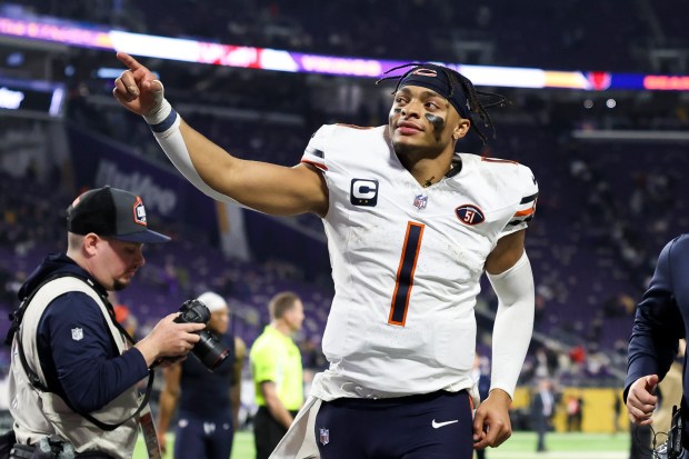 Chicago Bears quarterback Justin Fields (1) points toward fans as he runs off the field after the Chicago Bears defeated the Minnesota Vikings 12-10 at U.S. Bank Stadium in Minneapolis Nov. 27, 2023. (Eileen T. Meslar/Chicago Tribune)