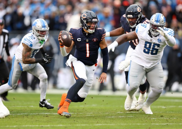 Chicago Bears quarterback Justin Fields (1) runs the ball in the first quarter of a game against the Detroit Lions at Soldier Field in Chicago on Dec 10, 2023. (Chris Sweda/Chicago Tribune)