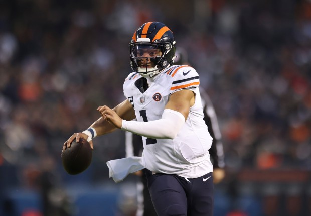 Bears quarterback Justin Fields looks for receivers downfield during the second quarter of a game between the Bears and Arizona Cardinals at Soldier Field on Christmas Eve, Dec. 24, 2023. (Trent Sprague/Chicago Tribune)