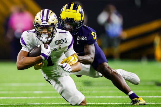 Washington wide receiver Rome Odunze makes a 44-yard reception against Michigan in the CFP national championship game on Jan. 8, 2024, at NRG Stadium in Houston. (Dean Rutz/The Seattle Times)