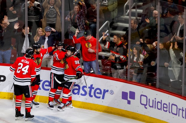 Chicago Blackhawks center Philipp Kurashev (23), center, and Chicago Blackhawks center Connor Bedard (98), celebrate Kurashev's goal along with other teammates during a game between the Chicago Blackhawks and the Pittsburgh Penguins on Thursday, Feb. 15, 2024, at the United Center in Chicago. (Vincent Alban/Chicago Tribune)