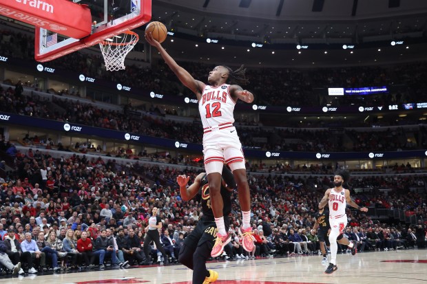 Bulls guard Ayo Dosunmu (12) soars to the rim for an easy two points against the Cavaliers in the first half at the United Center in Chicago on Feb. 28, 2024. (Terrence Antonio James/Chicago Tribune)