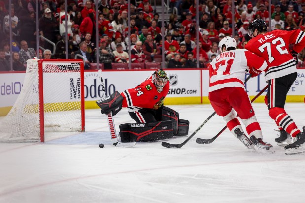 Chicago Blackhawks goaltender Petr Mrazek (34) blocks a shot from Detroit Red Wings center Dylan Larkin (71) during the second period at the United Center Sunday Feb. 25, 2024 in Chicago. (Armando L. Sanchez/Chicago Tribune)