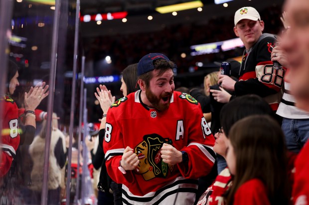 Fans celebrate after Chicago Blackhawks left wing Nick Foligno (17) scored a goal during the second period against the Detroit Red Wings at the United Center Sunday Feb. 25, 2024 in Chicago. (Armando L. Sanchez/Chicago Tribune)