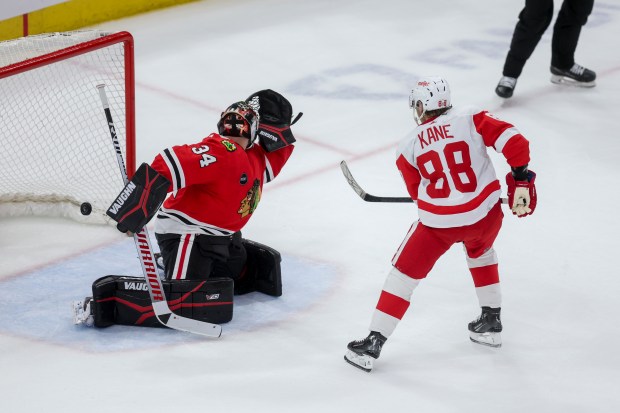 Detroit Red Wings right wing Patrick Kane (88) scores the game winning goal past Chicago Blackhawks goaltender Petr Mrazek (34) in overtime at the United Center Sunday Feb. 25, 2024 in Chicago. (Armando L. Sanchez/Chicago Tribune)