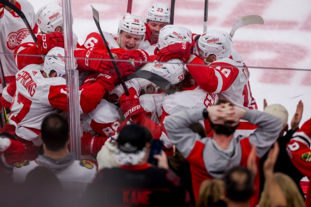 Detroit Red Wings right wing Patrick Kane (88) celebrates with his team after scoring the game winning goal past Chicago Blackhawks goaltender Petr Mrazek (34) in overtime at the United Center Sunday Feb. 25, 2024 in Chicago. (Armando L. Sanchez/Chicago Tribune)