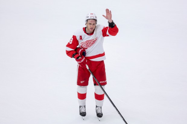 Detroit Red Wings right wing Patrick Kane (88) waves to the crowd after scoring the game winning goal past Chicago Blackhawks goaltender Petr Mrazek (34) in overtime at the United Center Sunday Feb. 25, 2024 in Chicago. (Armando L. Sanchez/Chicago Tribune)