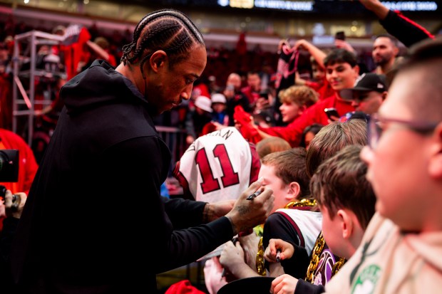 Chicago Bulls forward DeMar DeRozan (11) signs autographs during warmups before a game between the Chicago Bulls and the Minnesota Timberwolves on Tuesday, Feb. 6, 2024, at the United Center in Chicago. (Vincent Alban/Chicago Tribune)