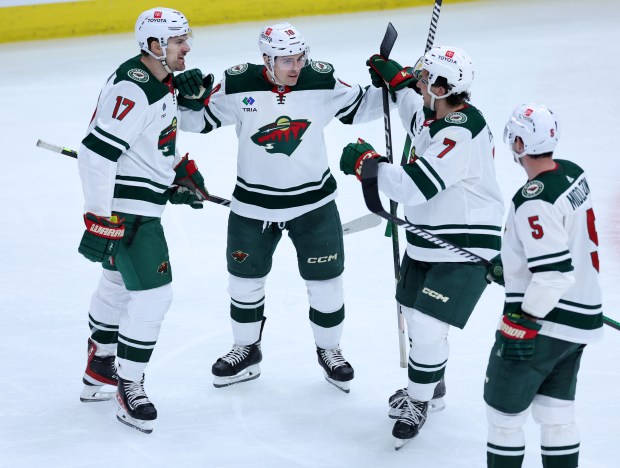 Minnesota Wild left wing Marcus Foligno (left) celebrates with his teammates after scoring a goal in the third period of a game against the Chicago Blackhawks at the United Center in Chicago on Feb. 7, 2024. (Chris Sweda/Chicago Tribune)