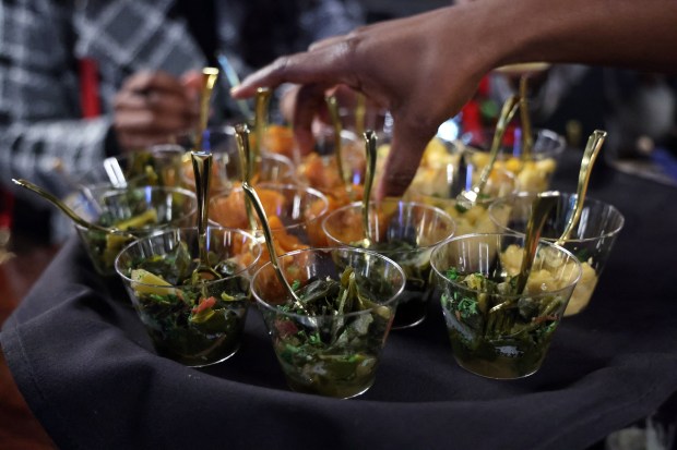 Small bites including greens, sweet potatoes and macaroni and cheese were served at Kitchen + Kocktails restaurant in Chicago's River North neighborhood during a Chicago Black Restaurant Week event on Friday, Feb. 9, 2024. (Terrence Antonio James/Chicago Tribune)