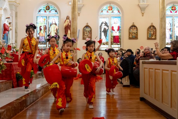 Children from St. Therese School perform a drum dance to celebrate Lunar New Year during Mass on Feb. 11, 2024, at St. Therese Chinese Catholic Church in Chinatown. The Year of the Dragon began Saturday. (Brian Cassella/Chicago Tribune)