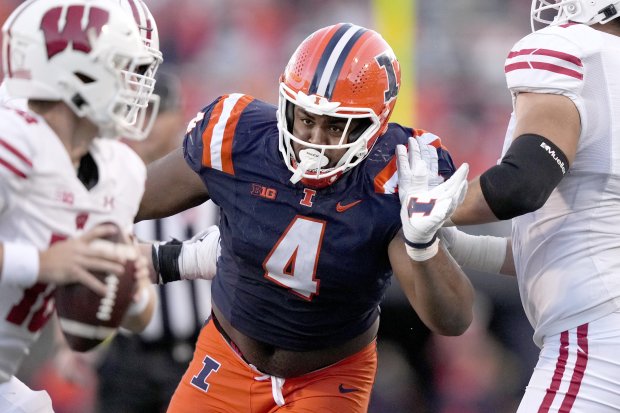 Illinois defensive lineman Jer'Zhan Newton rushes the quarterback during an NCAA college football game against Wisconsin Saturday, Oct. 21, 2023, in Champaign, Ill. (AP Photo/Charles Rex Arbogast)