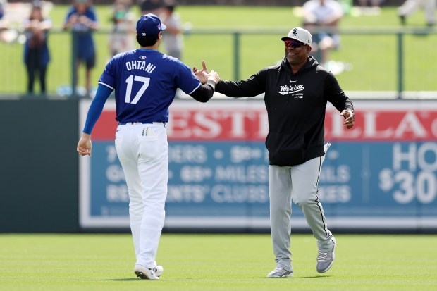 The Dodgers' Shohei Ohtani greets White Sox hitting coach Marcus Thames before the game Tuesday, Feb. 27, 2024, in Glendale, Ariz. (Christian Petersen/Getty Images)