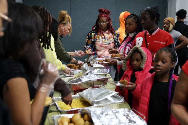 Clients of the organization UCAN SheRo program share a meal on Feb. 9, 2024.(Terrence Antonio James/Chicago Tribune)