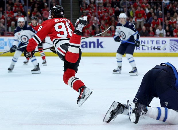 Blackhawks center Connor Bedard (98) goes airborne as he is tripped in the third period against the Jets on Feb. 23, 2024, at the United Center. (Chris Sweda/Chicago Tribune)