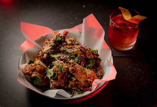 The General Jones chicken wings and the Cheating Death cocktail at Nine Bar on Feb. 13, 2023. (Brian Cassella/Chicago Tribune)